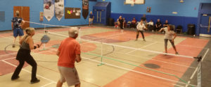 group of pickleball players in the gymnasium